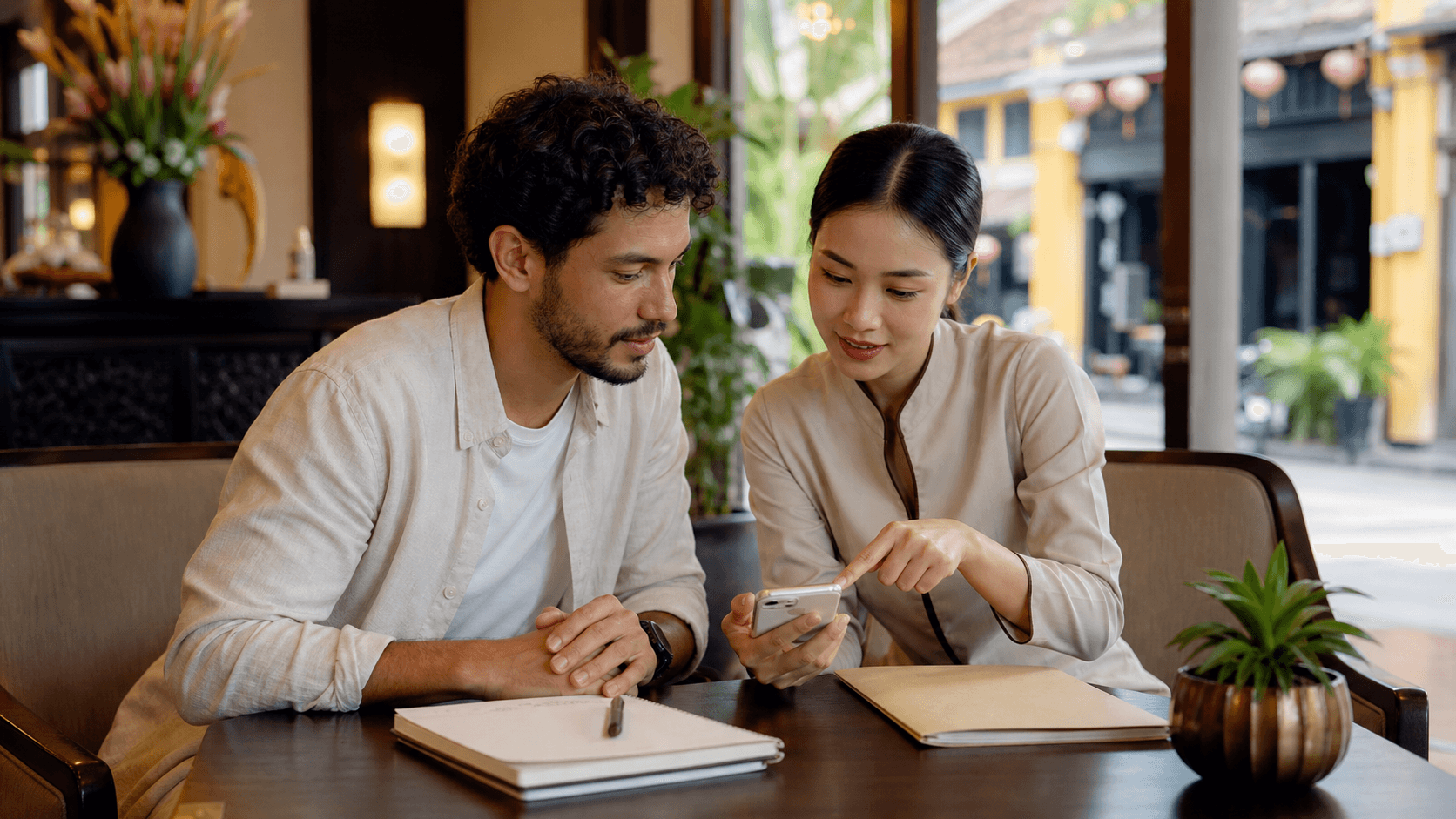 International traveler organizing emergency documents with a hotel concierge in Hoi An